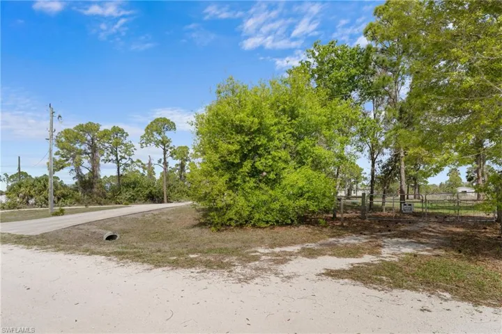 View of dirt / gravel road with a gate
