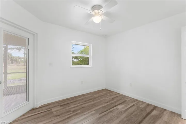 Unfurnished room featuring wood finished floors and ceiling fan