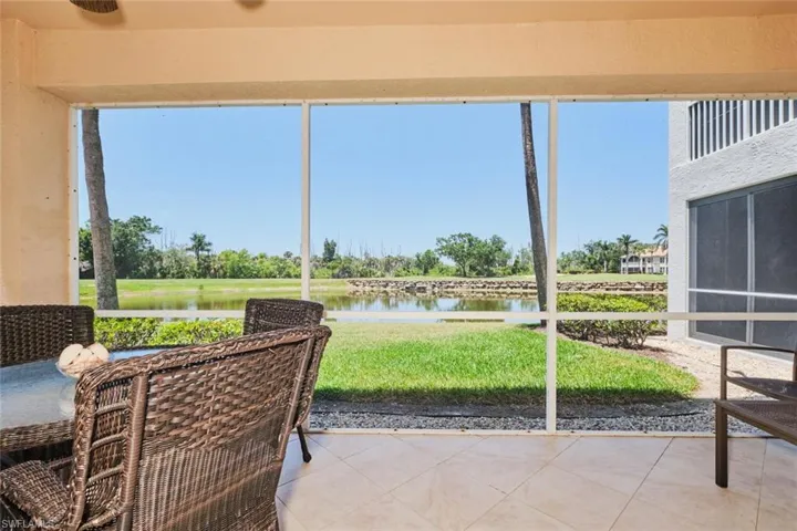 Sunroom / solarium with a water view and healthy amount of natural light