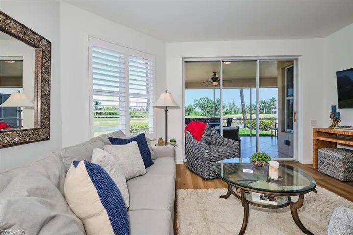 Living area with wood finished floors and ceiling fan
