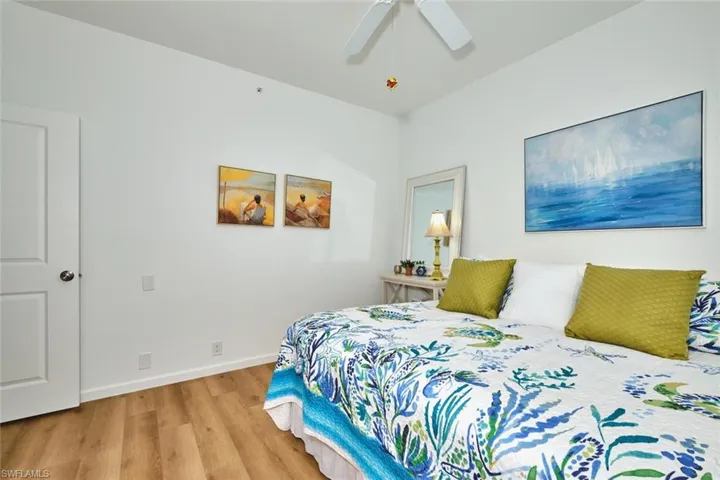 Bedroom with light wood-type flooring, ceiling fan, and baseboards