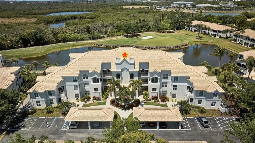 Drone / aerial view of a nearby body of water and a golf club