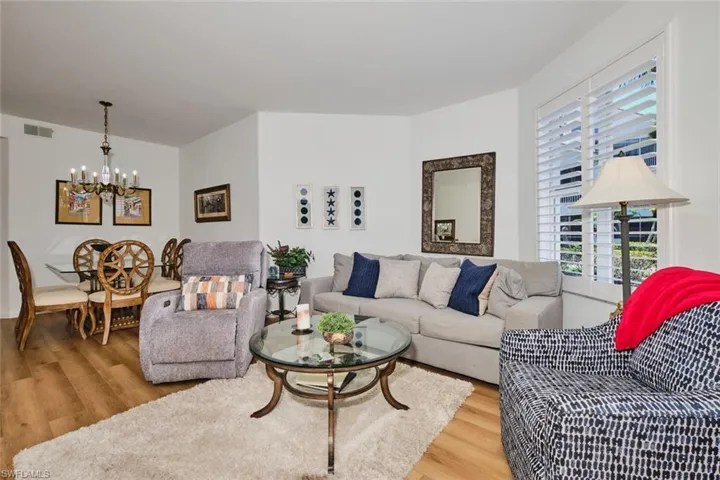 Living area featuring a chandelier, wood finished floors, and plenty of natural light