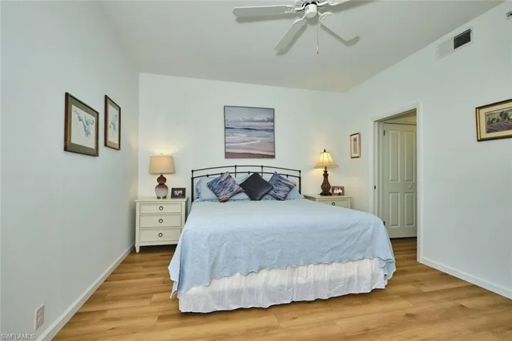 Bedroom featuring baseboards, light wood-style floors, and a ceiling fan