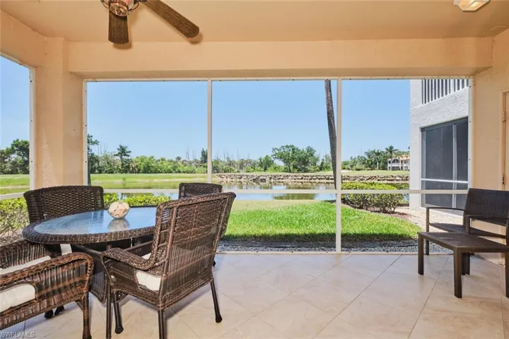 Sunroom / solarium with ceiling fan, a water view, and outdoor dining area