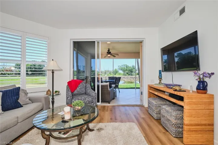 Living room with wood finished floors and a ceiling fan