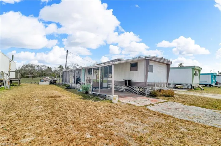 View of front with fence, a patio area, and a front yard