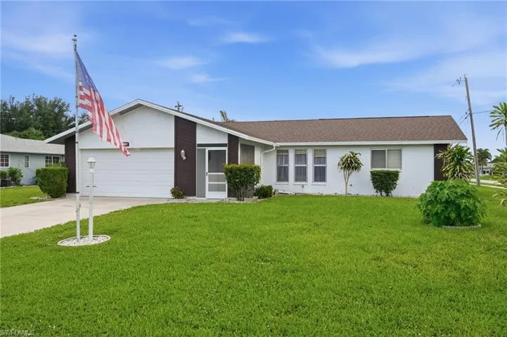 Single-story residence featuring a white exterior with brown accents and a dark brown roof