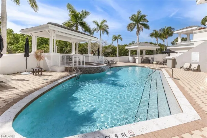 View of pool with a patio area, pool water feature, and a gazebo