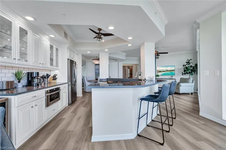 Kitchen featuring ceiling fan, appliances with stainless steel finishes, and light hardwood / wood-style floors