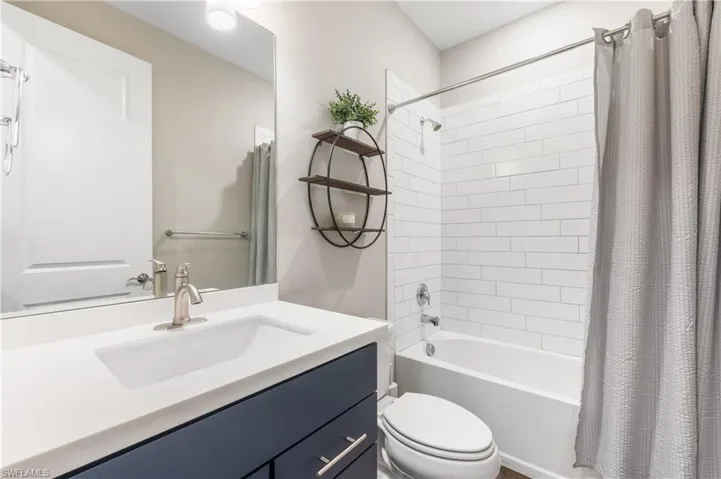 Bathroom featuring vanity and shower / bath combo