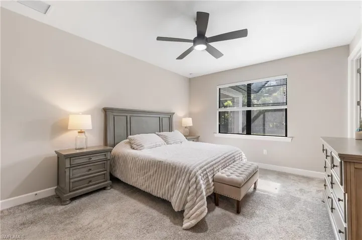 Bedroom featuring light carpet and ceiling fan