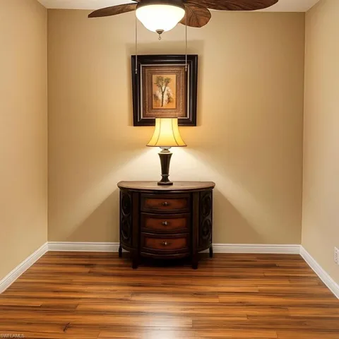 Detailed view of wood finished floors and ceiling fan