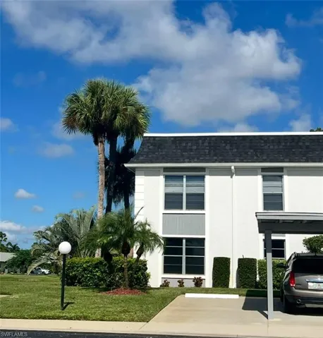 View of property with uncovered parking
