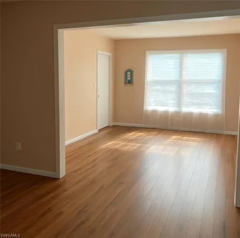Spare room featuring baseboards and light wood-style floors