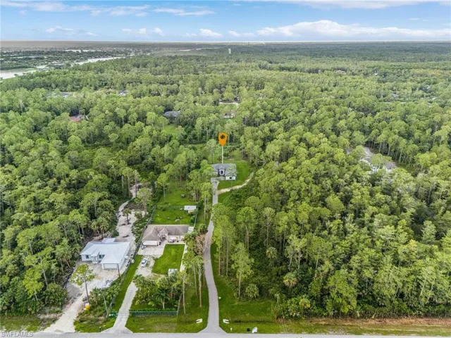 View of property location with a heavily wooded area