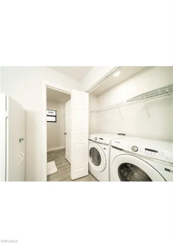 Clothes washing area featuring light hardwood / wood-style flooring and independent washer and dryer