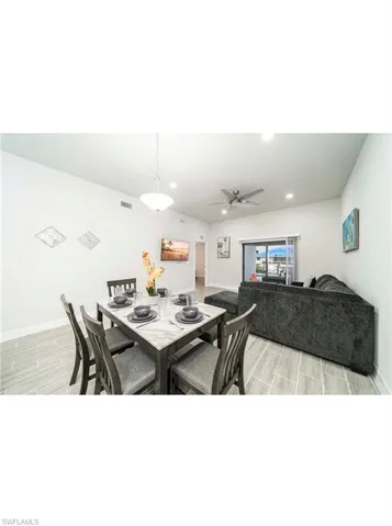 Dining area with light wood-type flooring and ceiling fan
