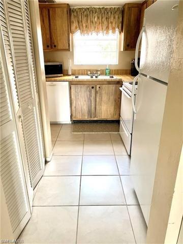 Kitchen with window over sink overlooking courtyard entry