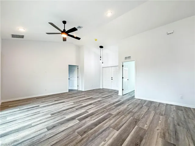 Unfurnished room featuring high vaulted ceiling, light wood finished floors, a ceiling fan, and recessed lighting