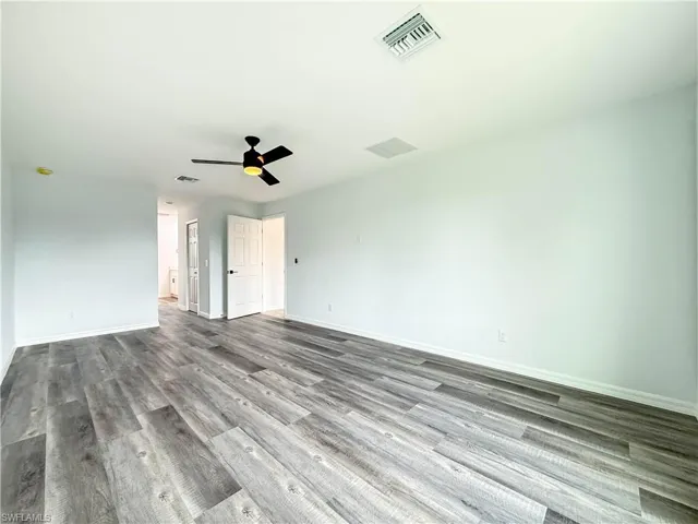 Unfurnished bedroom featuring wood finished floors and a ceiling fan
