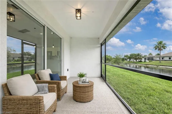 Sunroom featuring a water view