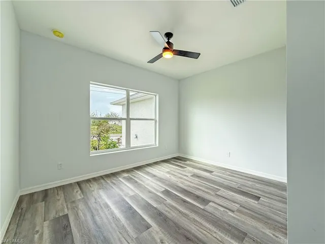 Empty room featuring light wood-style floors and ceiling fan