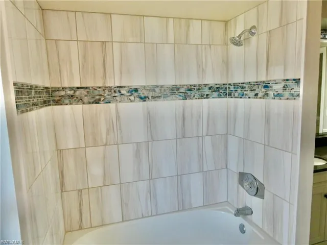 Bathroom view of shower / washtub combination and vanity