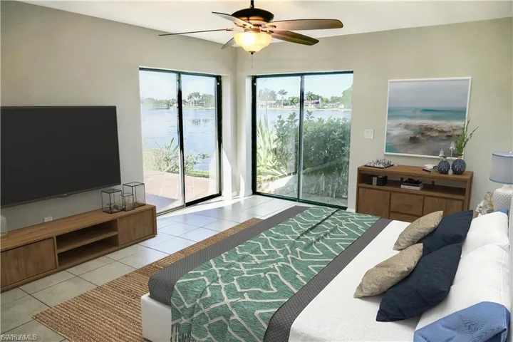 Primary featuring light tile patterned flooring, multiple windows, a water view, and a ceiling fan