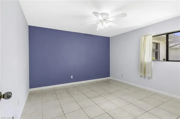 Unfurnished 2nd Guest bedroom featuring light tile patterned flooring and ceiling fan