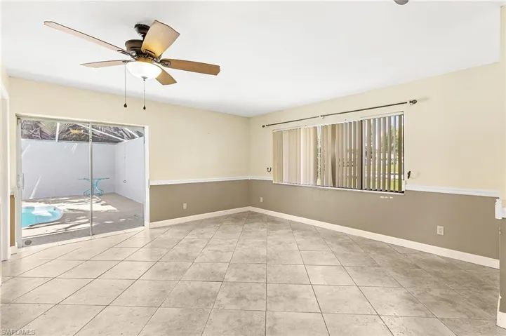 Empty room featuring ceiling fan and light tile patterned flooring