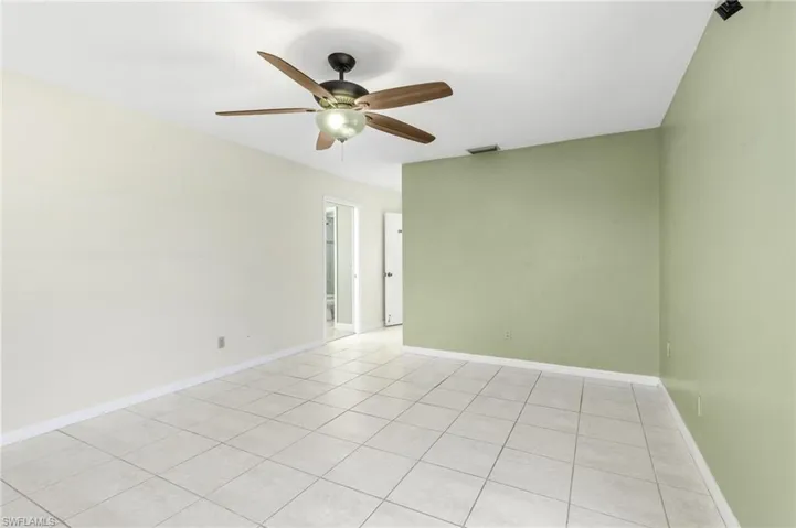 Unfurnished Primary room featuring light tile patterned floors and a ceiling fan