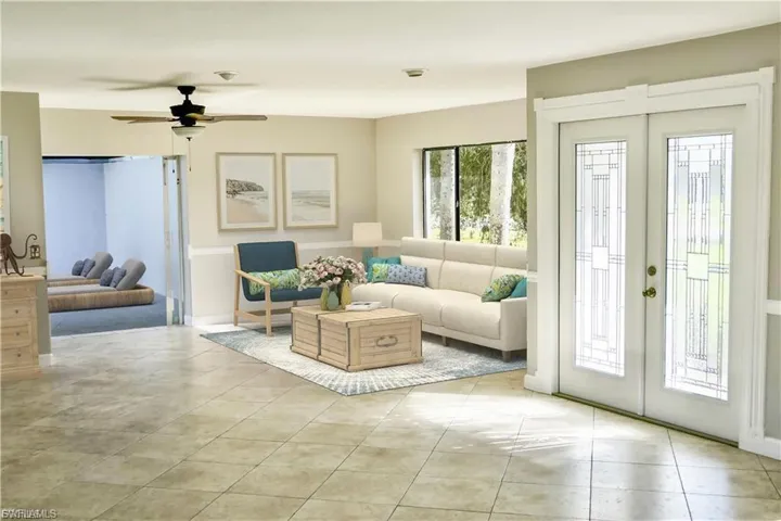 Living room featuring french doors, light tile patterned floors, and a ceiling fan