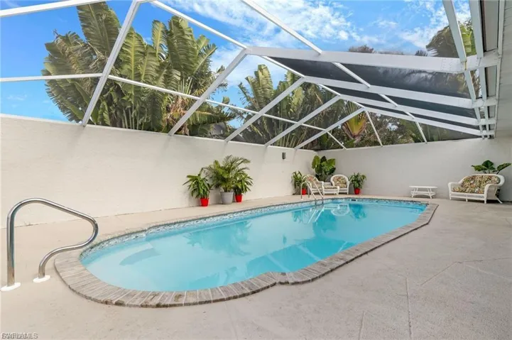 Outdoor pool with privacy wall, a patio area