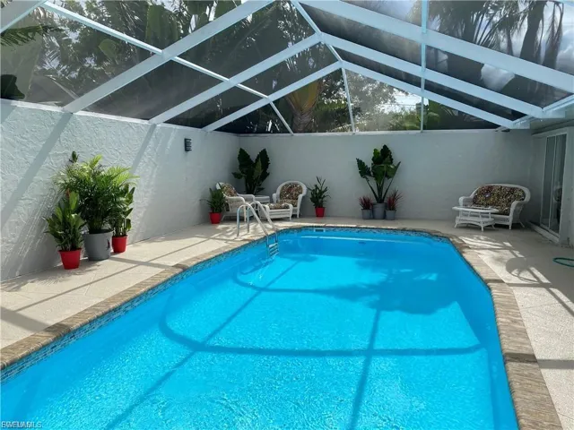 Outdoor pool with a patio area and a lanai