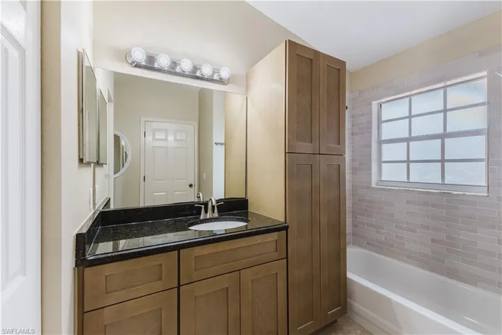 Bathroom with vanity and bathtub / shower combination