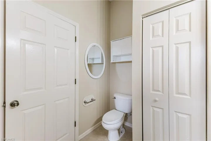 Bathroom featuring a closet and light tile patterned flooring