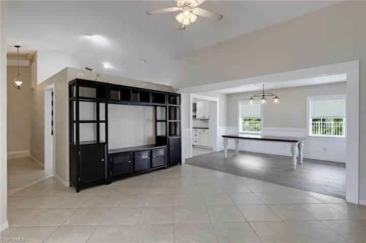 Unfurnished living room featuring light tile patterned floors and ceiling fan
