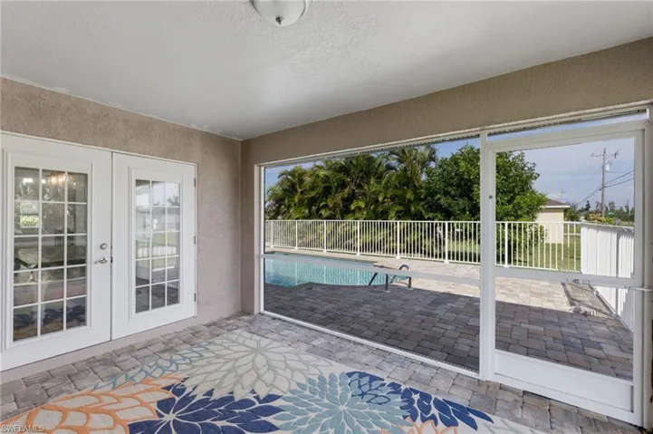 Unfurnished sunroom featuring french doors