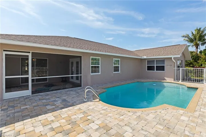 View of pool featuring patio surround and french doors