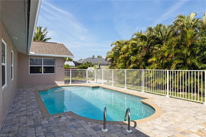 View of swimming pool with a fenced backyard and patio surround