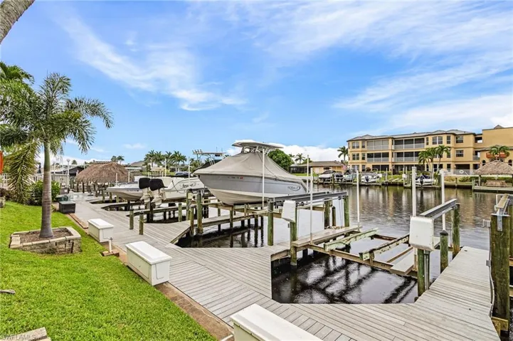 Dock featuring boat lift and a water view