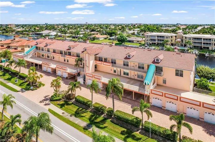 Aerial view of apartment complex and a large body of water