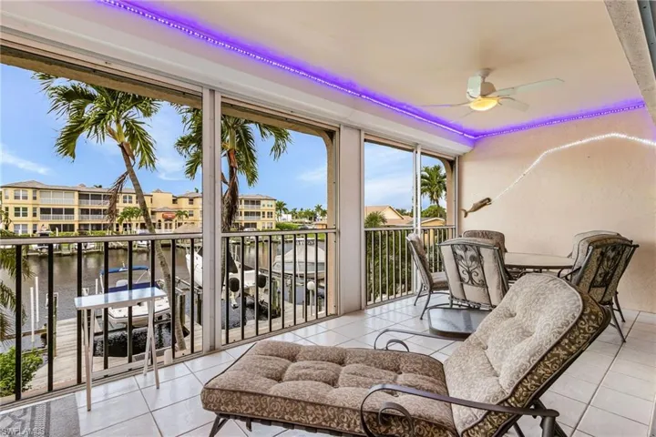 Sunroom featuring a water view