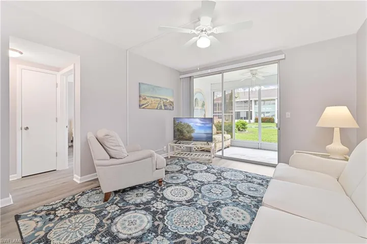 Living room featuring wood finished floors and a ceiling fan