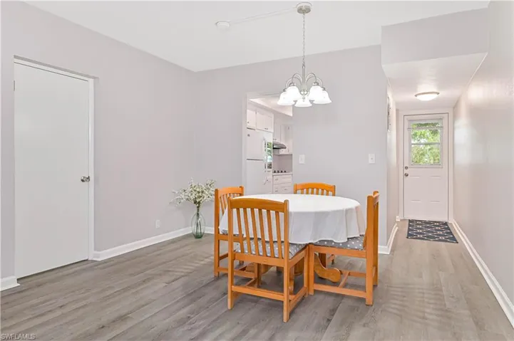 Dining area featuring light wood-style flooring and a chandelier