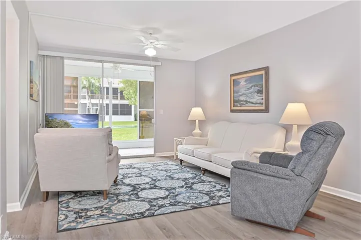 Living room with a ceiling fan and wood finished floors