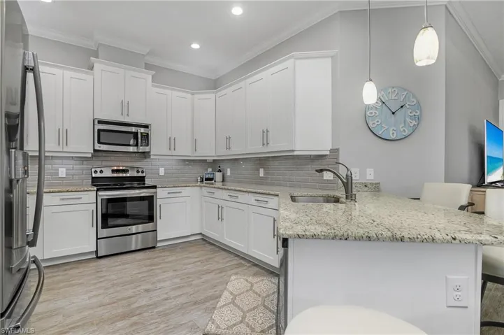 HUGE kitchen with plenty of cabinet space, stainless steel appliances, stone granite countertops, and a spacious breakfast bar.