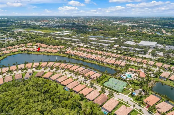 Birds eye view of property with a water view