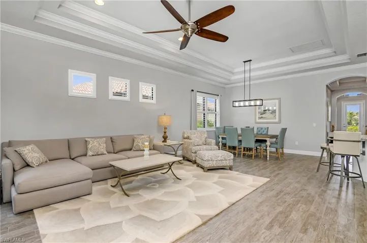 High ceilings, decorative crown molding, and wood-look porcelain tile floors give this home a coastal elegance.